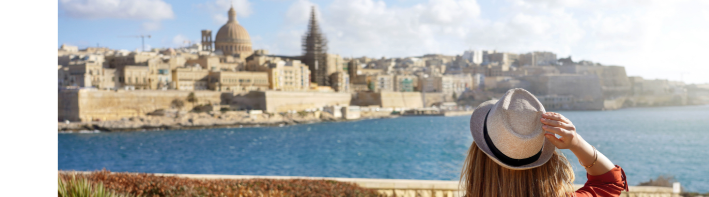 Individual overlooking Valletta, Malta, representing relocation and residence opportunities.