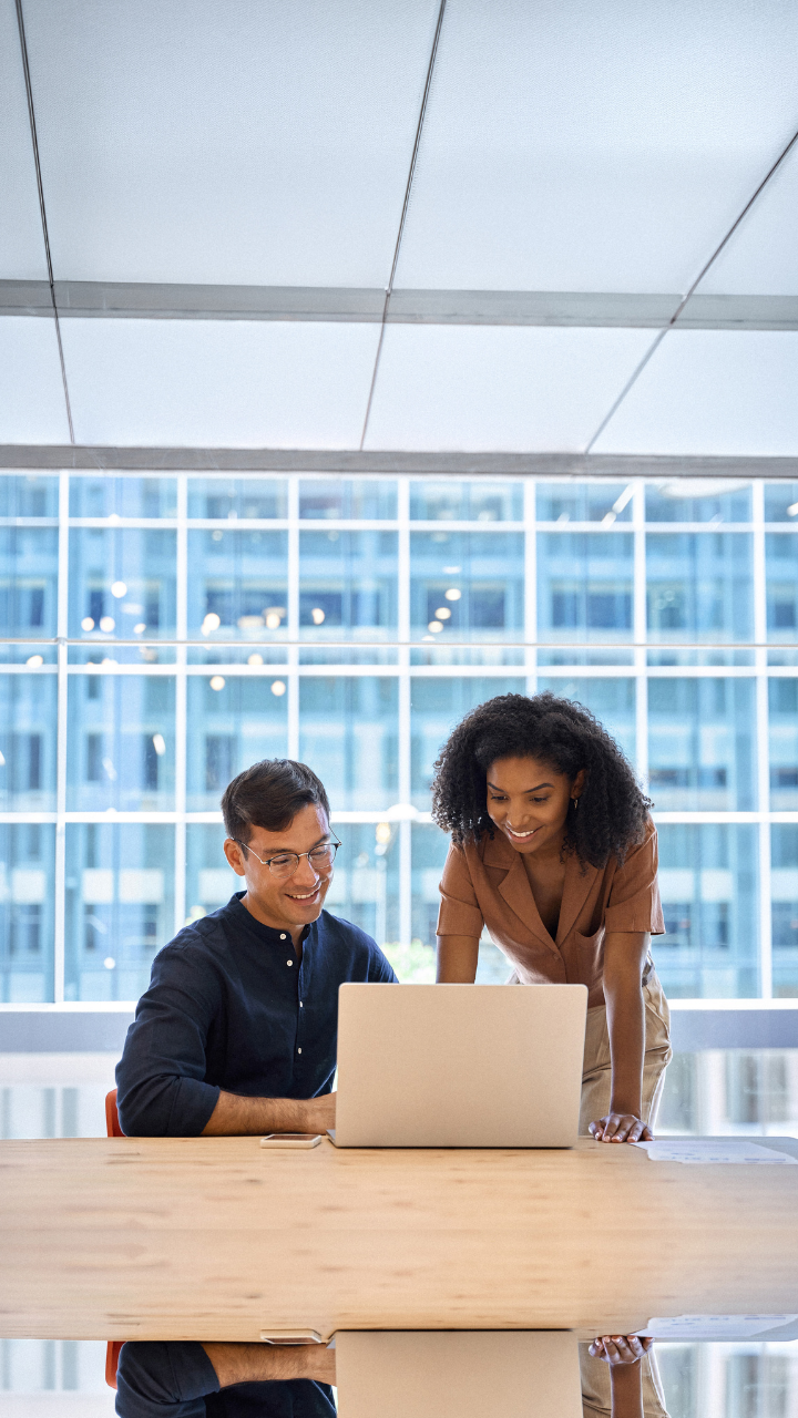 Business professional reviewing corporate compliance documents in a modern office.
