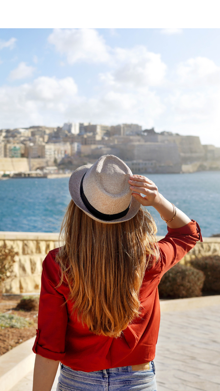 Individual overlooking Valletta, Malta, representing relocation and residence opportunities.