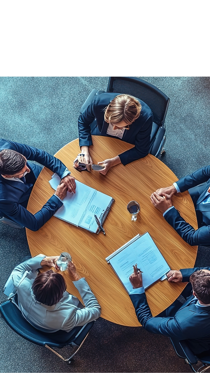 Financial services professionals reviewing documents during a risk management meeting.