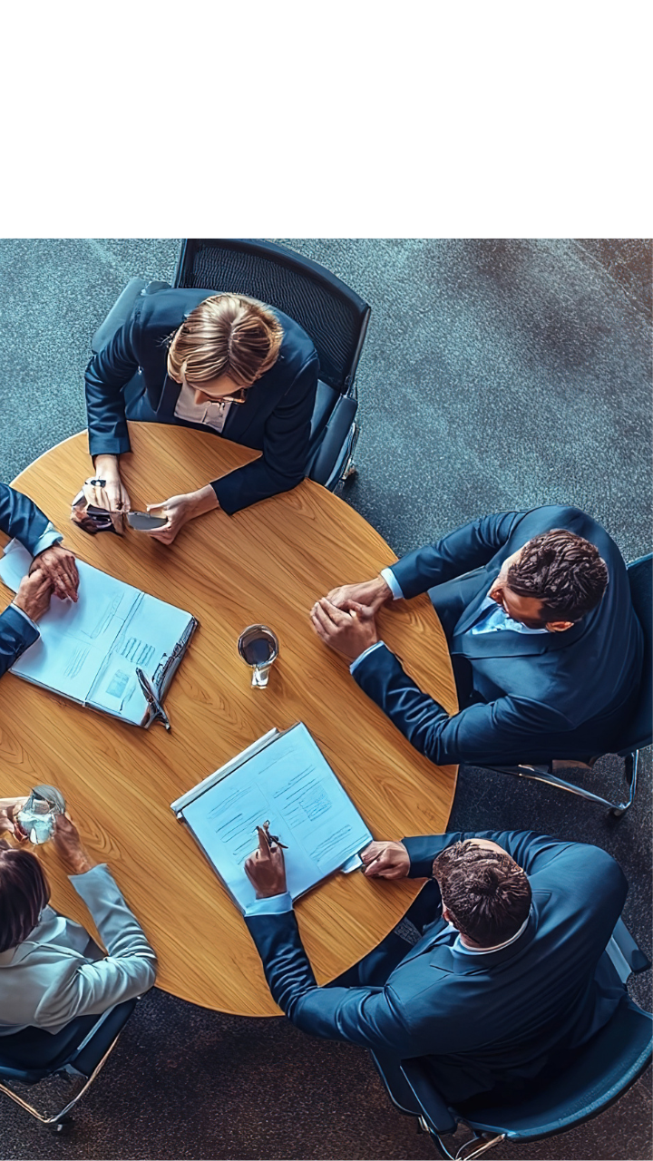 Financial services professionals reviewing documents during a risk management meeting.