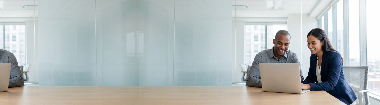 Two professionals in conversation in an office with bookshelves in the background.
